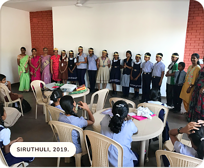School students in uniform gathered for a Siruthuli session, 2019
